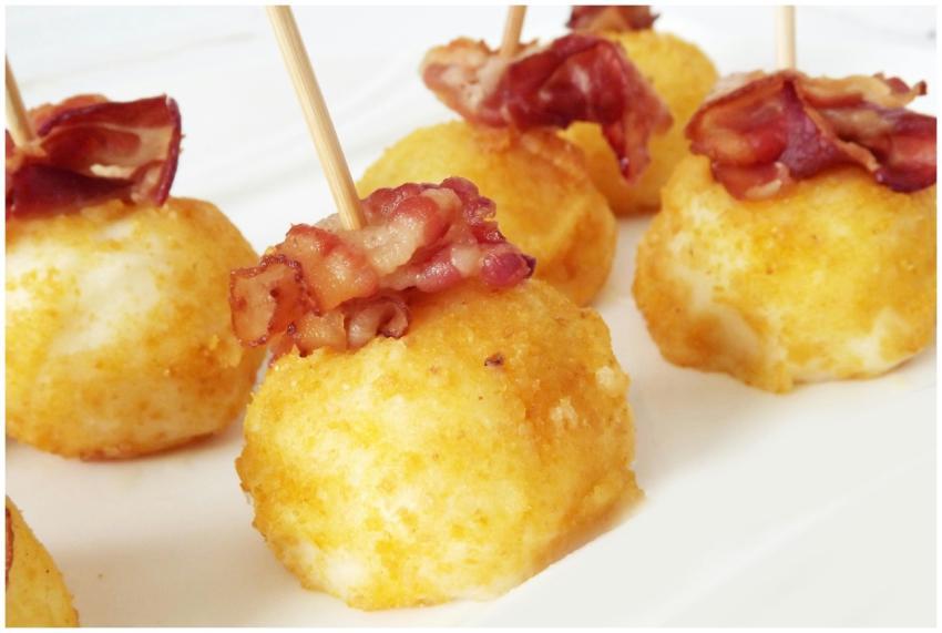 Golden potato croquettes topped with crispy bacon,