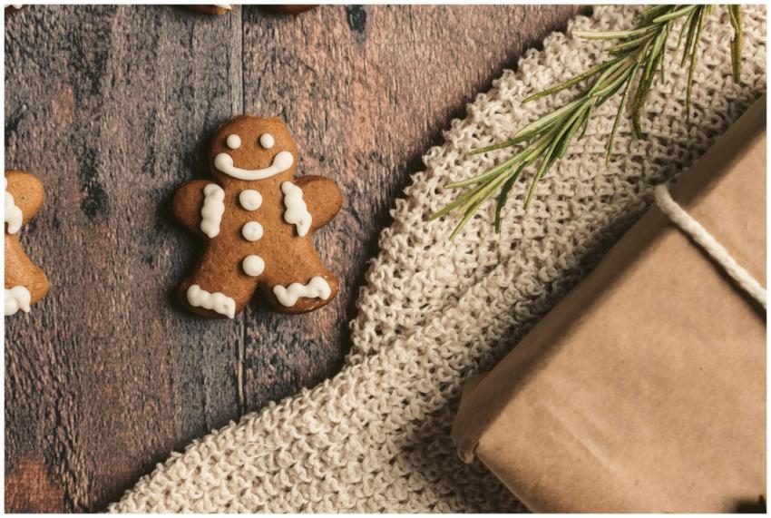 Close-up of a gingerbread man cookie with gift and