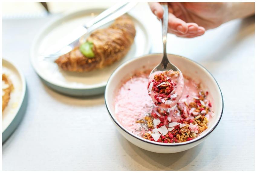 A vibrant breakfast scene with a berry yogurt bowl