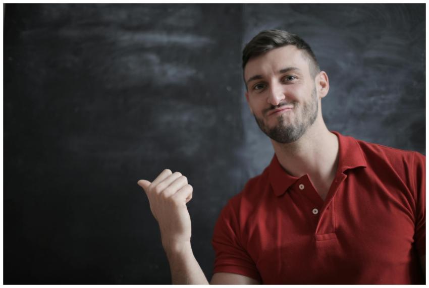 Portrait of a young man in a red polo, gesturing c