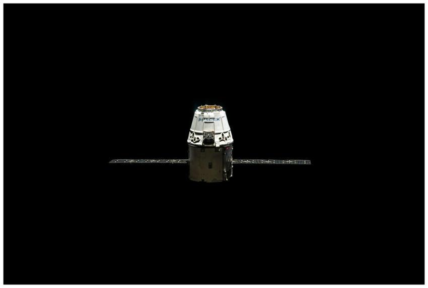 A SpaceX Dragon capsule orbited against the dark v