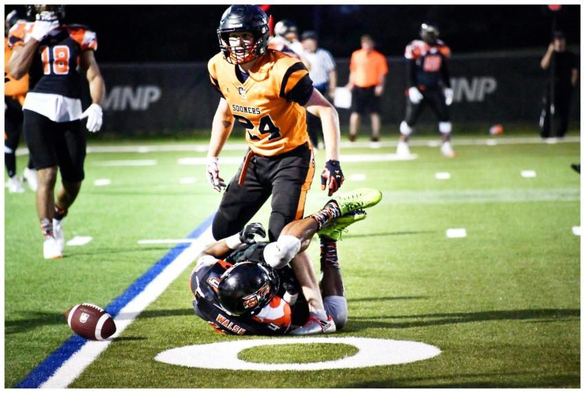 Dramatic tackle during a nighttime football game w