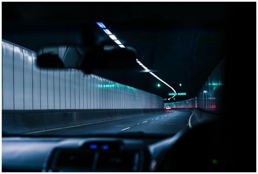 Inside view of a car driving through a brightly li