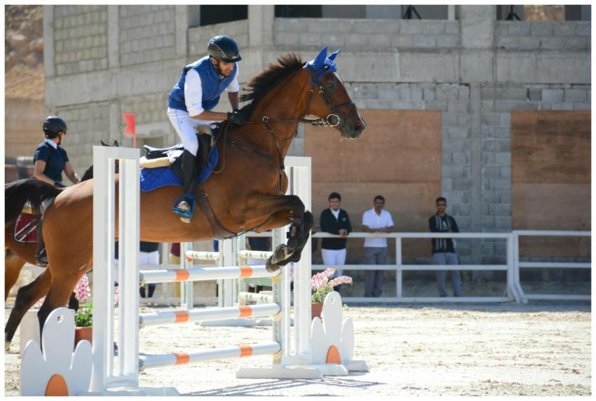 Intense equestrian jumping event showcasing skill