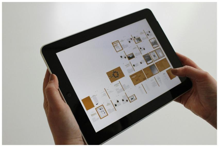 Close-up of hands using a tablet, displaying a dig