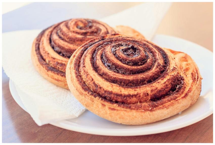 A close-up view of two freshly baked cinnamon roll