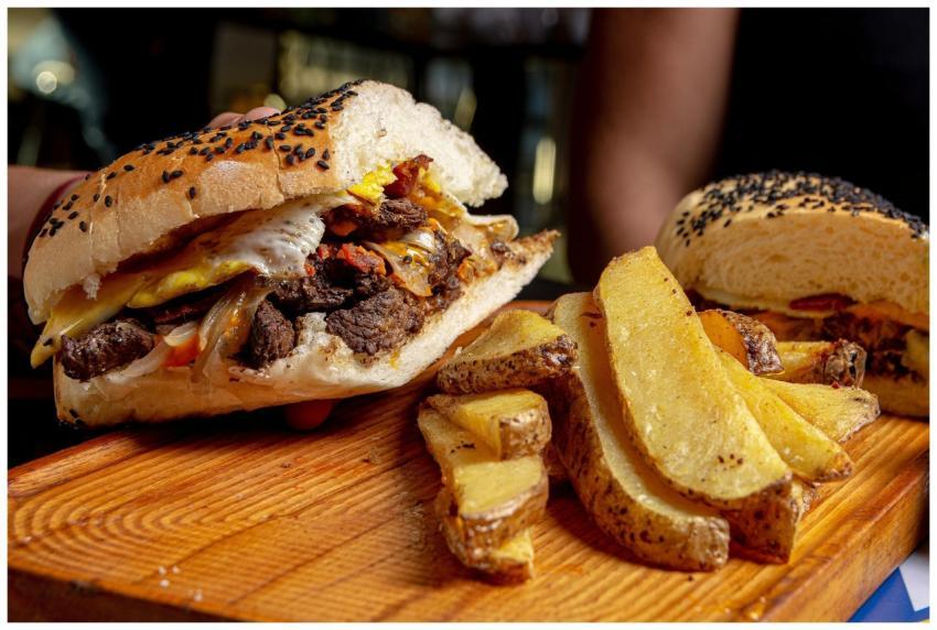 Delicious cheeseburger with crispy steak fries, pe