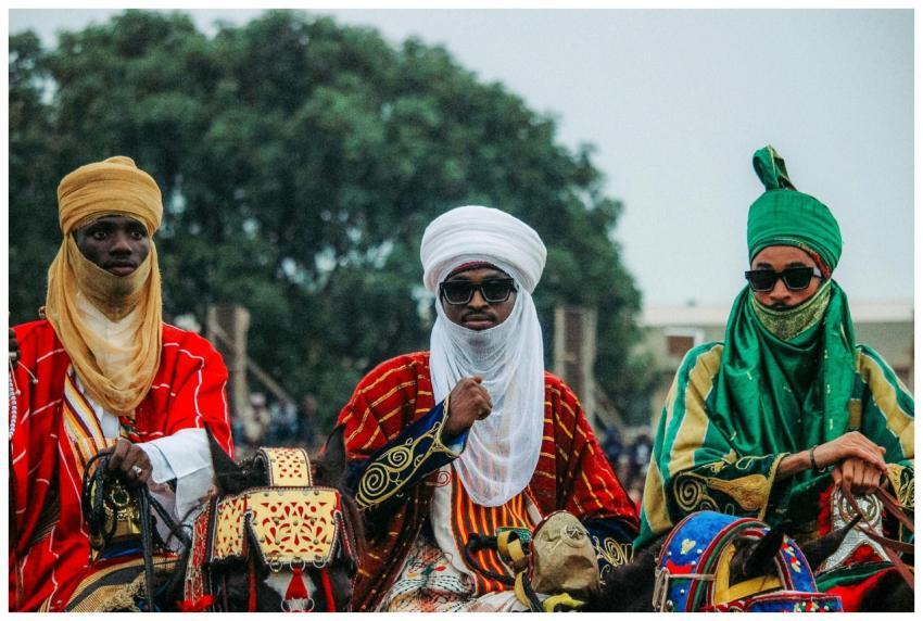 Three men in colorful traditional robes and turban