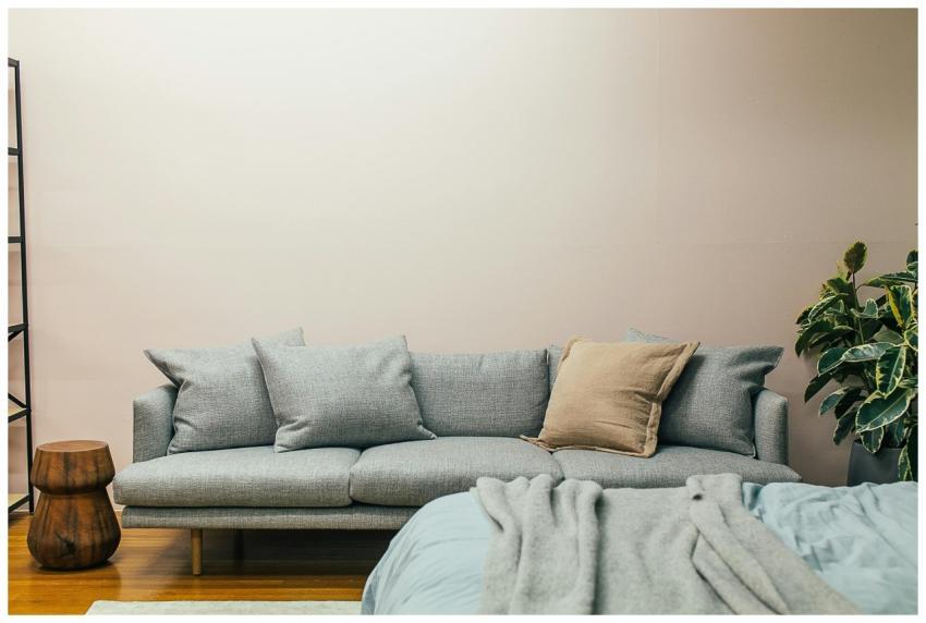 A serene living room with a cozy sofa, wooden stoo