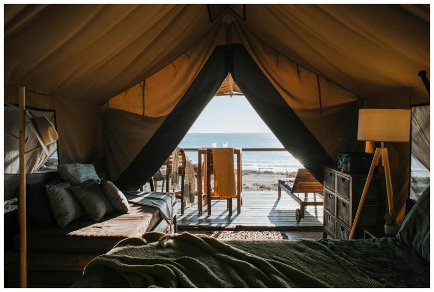 A luxurious tent setup with a view of the ocean, p