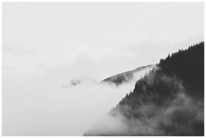 Serene black and white landscape of misty mountain