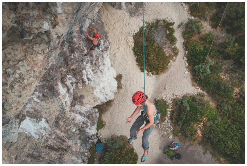 From above of anonymous people hanging on ropes wh