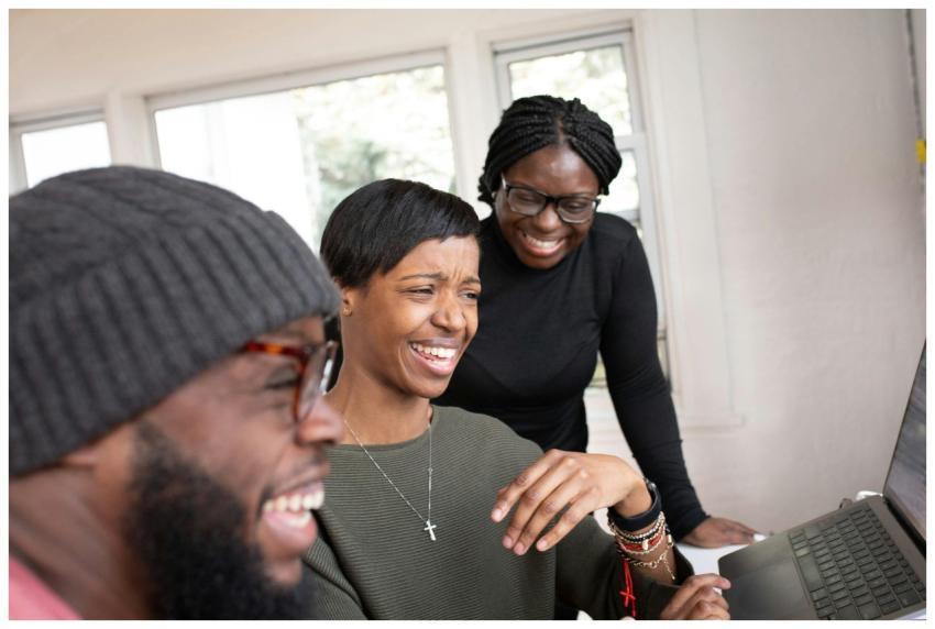 Three friends share a joyful moment while interact