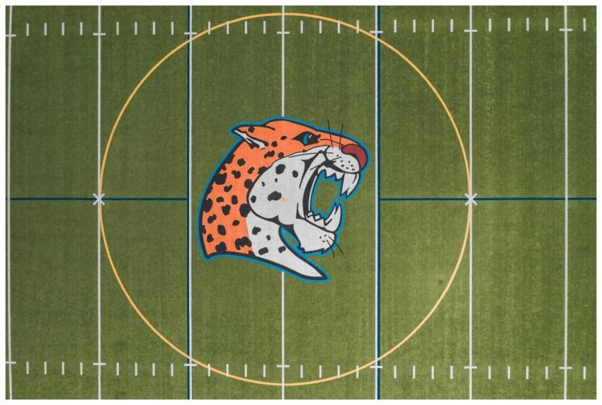 Drone shot of a football field featuring a promine