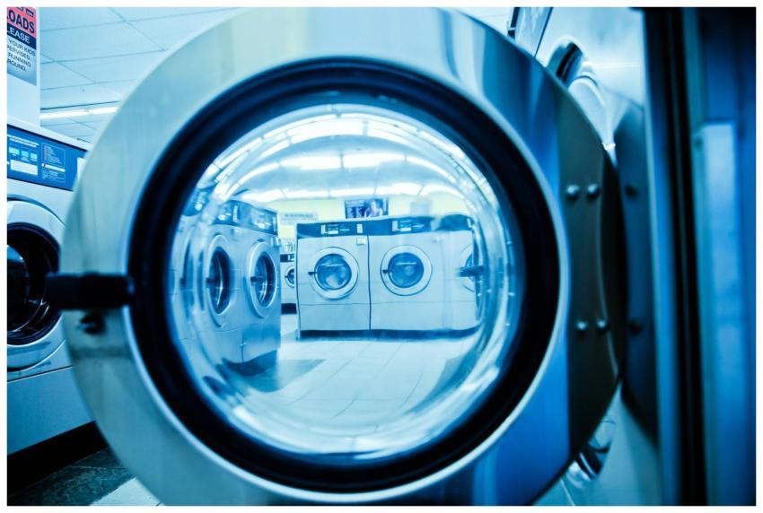 Interior view of a modern laundromat with rows of