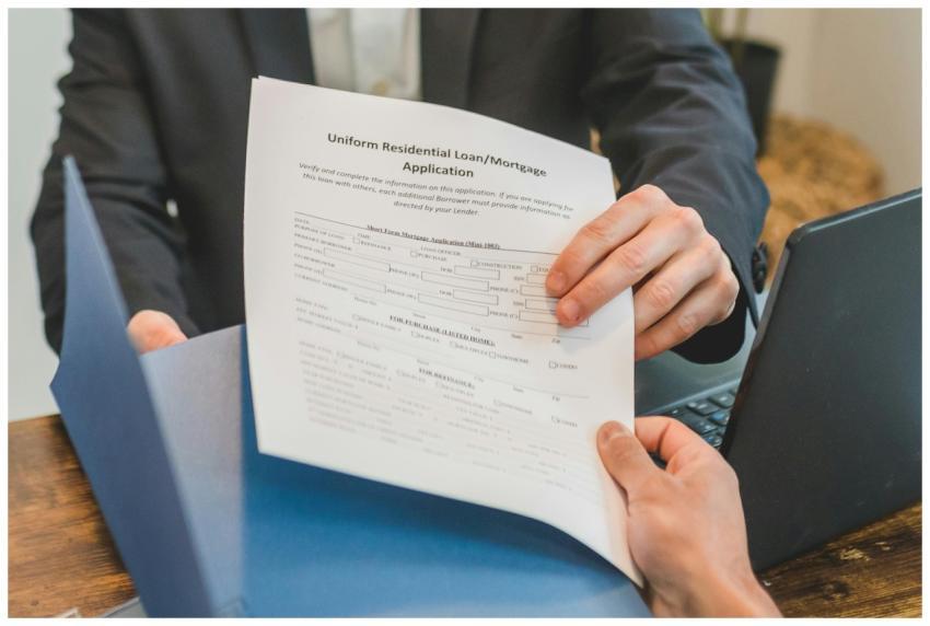 Professional setting showing hands exchanging a mo