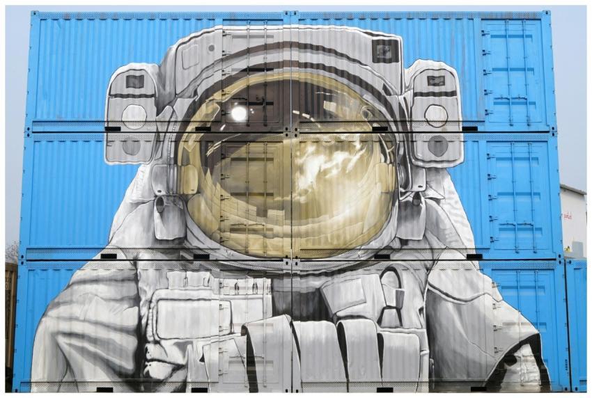 Astronaut mural painted on blue shipping container