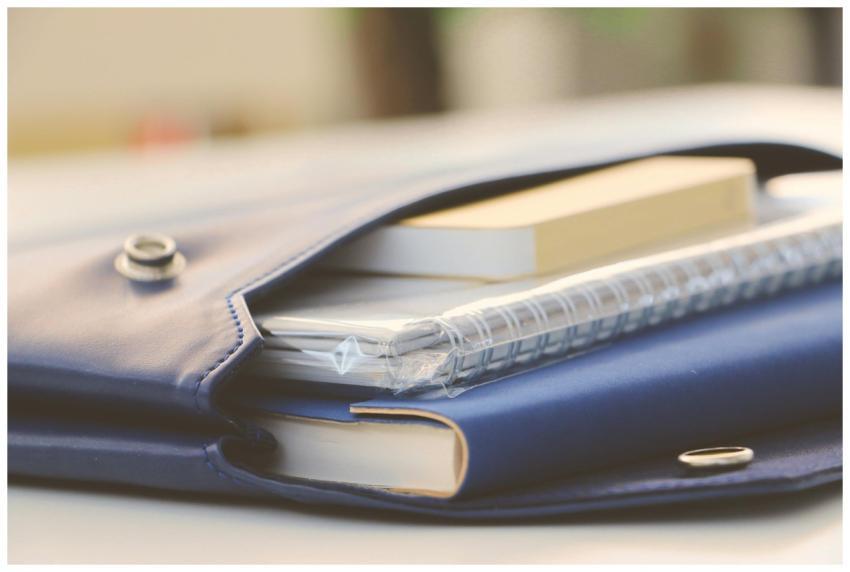 Close-up of a stylish blue portfolio containing va