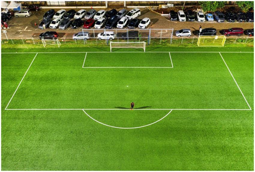 Aerial view of a soccer field at night in Jakarta