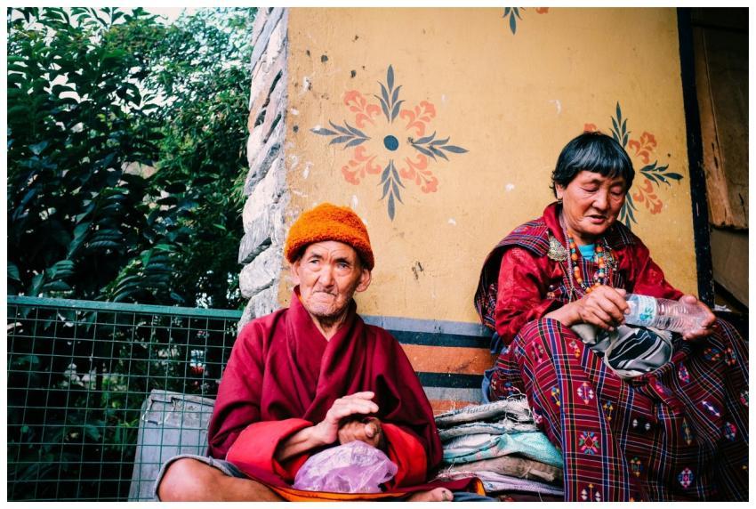 Two elderly Bhutanese individuals in traditional a