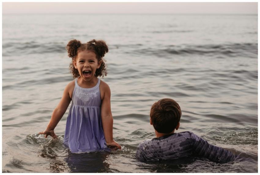 Two children enjoying a fun day at the beach, spla