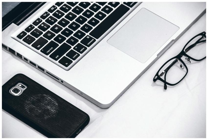 Close-up of a modern workspace featuring a laptop,