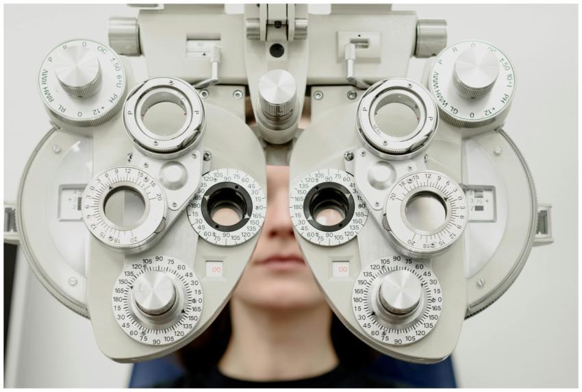 Woman diagnosing vision on refractor testing devic