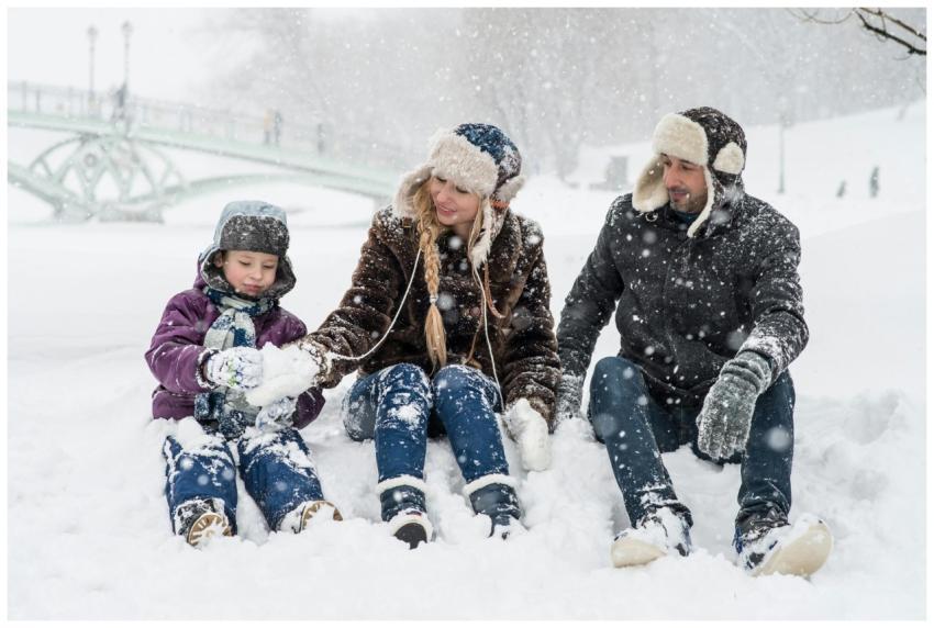 Happy family enjoying playful time in snowy winter