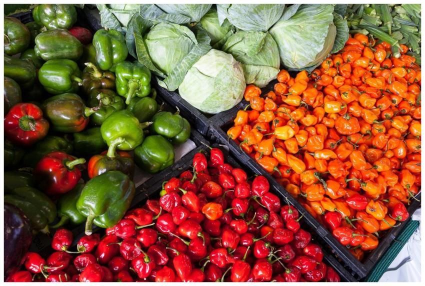 A vibrant display of fresh vegetables including pe