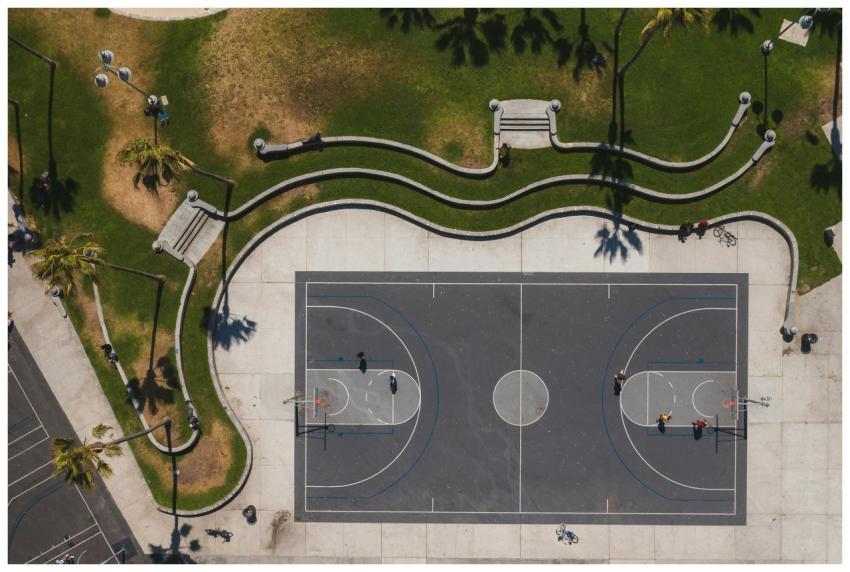 Aerial shot of a basketball court in a sunny park