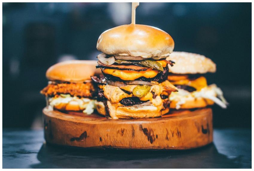 Close-up of a delicious cheeseburger trio with jui