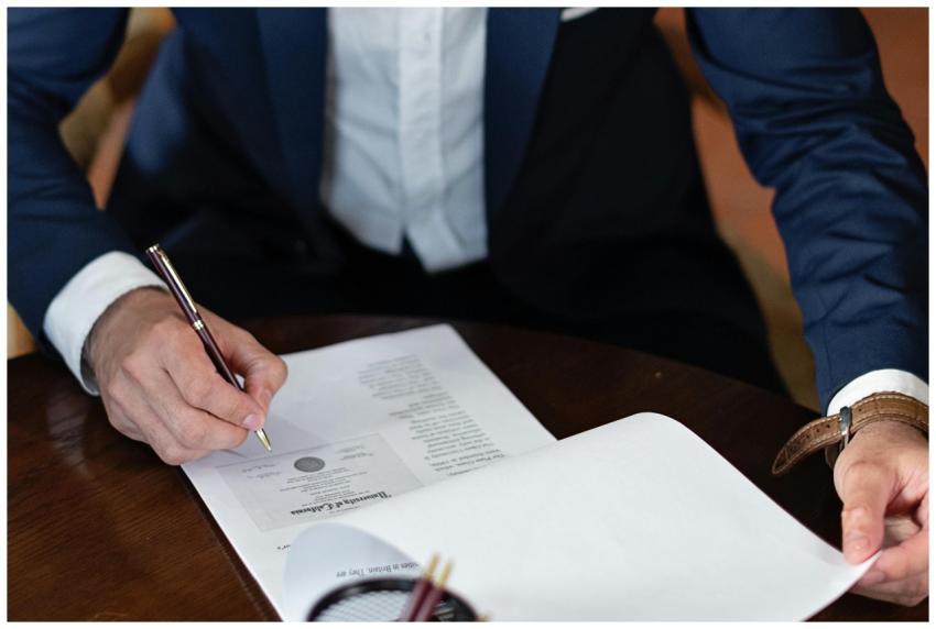 A professional individual signs legal documents at