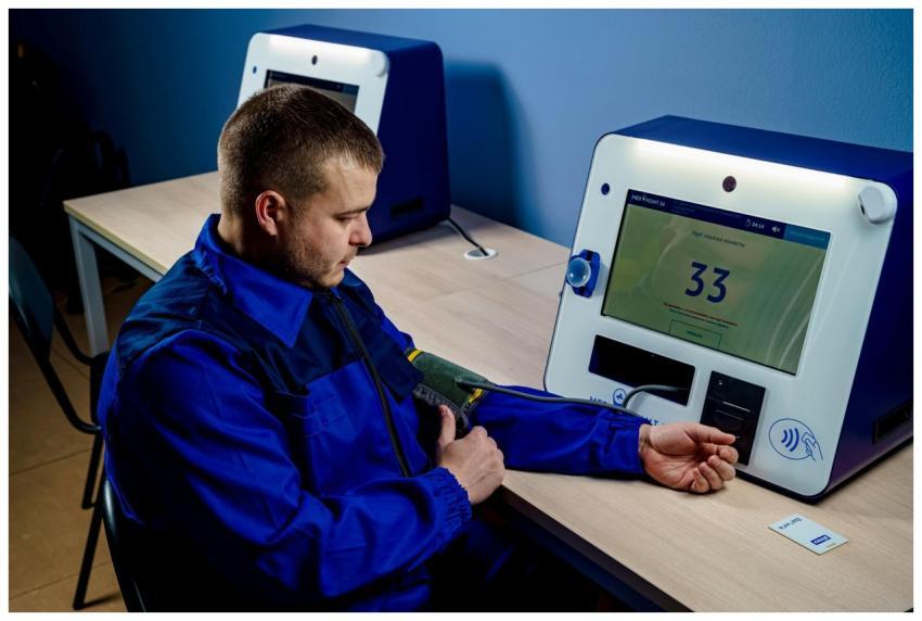 A man uses a modern machine to measure his blood p