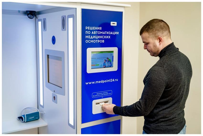 A person interacts with an automated medical kiosk