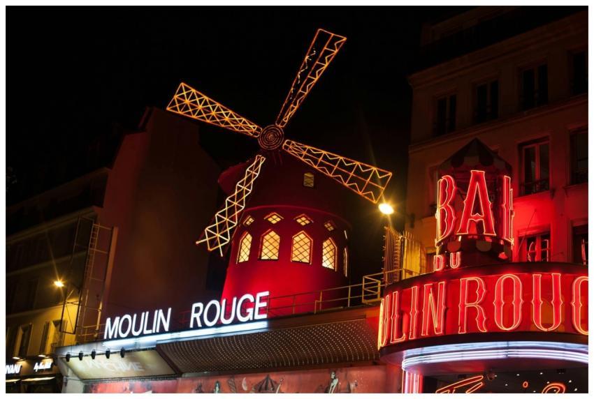Brightly illuminated Moulin Rouge windmill in Pari