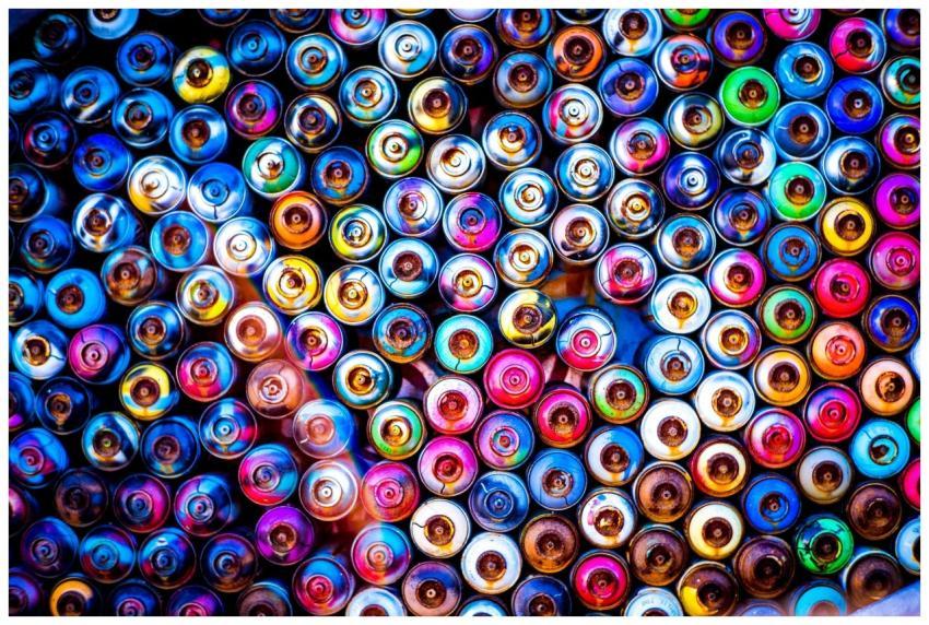 Colorful top view of spray paint cans displaying a