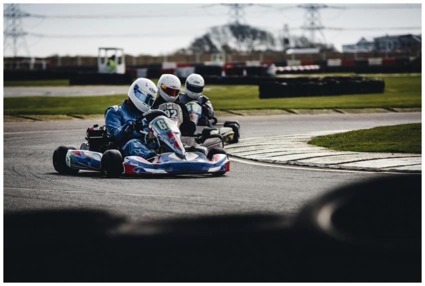 Competitive go-kart race on an outdoor track, show