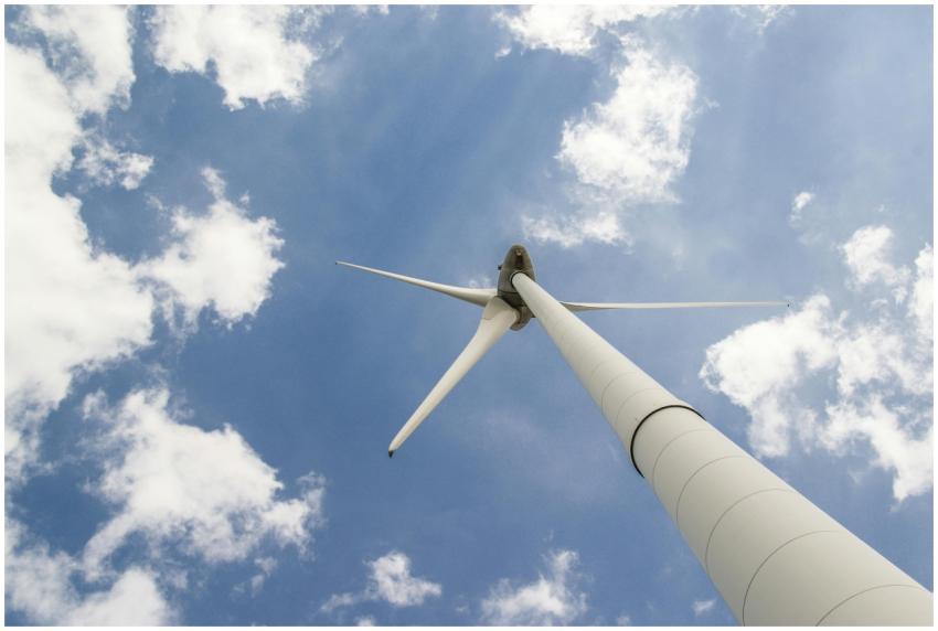 View of a towering wind turbine against a cloudy b