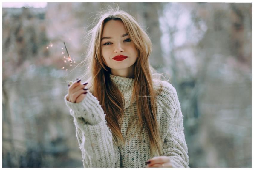 Portrait of a young woman with long hair and red l