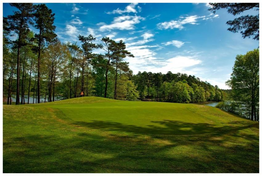 Beautiful golf course surrounded by trees and lake