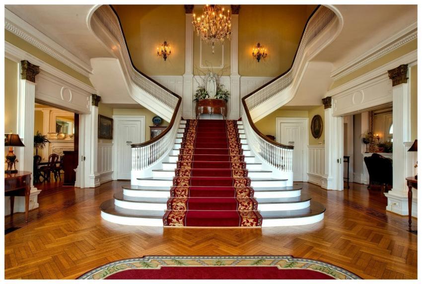 Grand staircase with red carpet in a luxurious hot