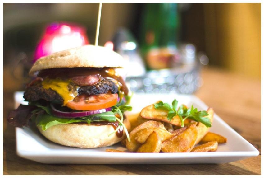 Savor a juicy cheeseburger served with crispy frie