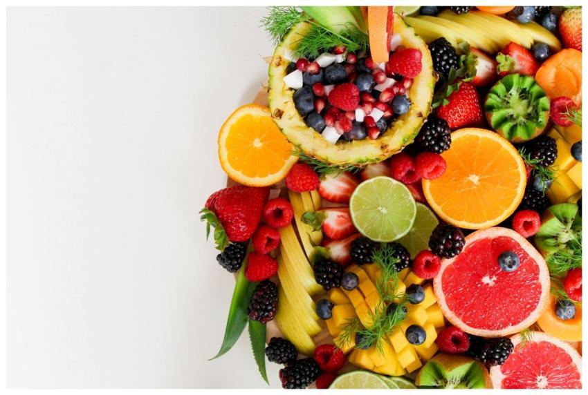 Colorful flat lay of assorted tropical fruits incl