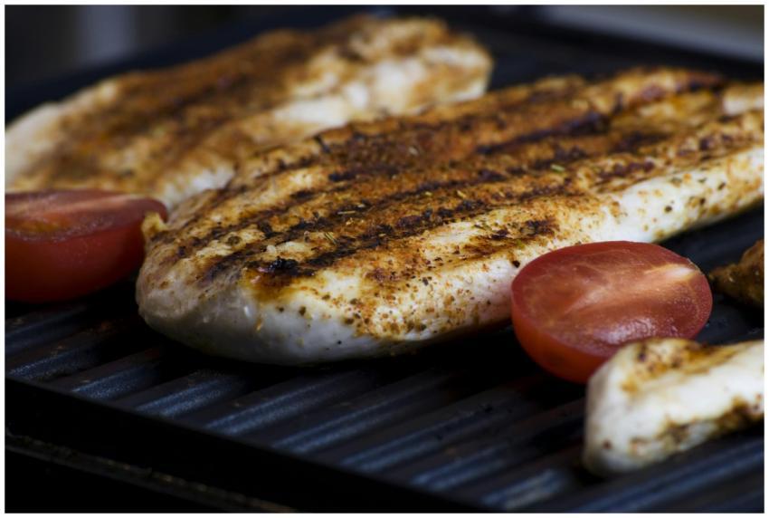 Close-up of grilled chicken breasts with tomatoes