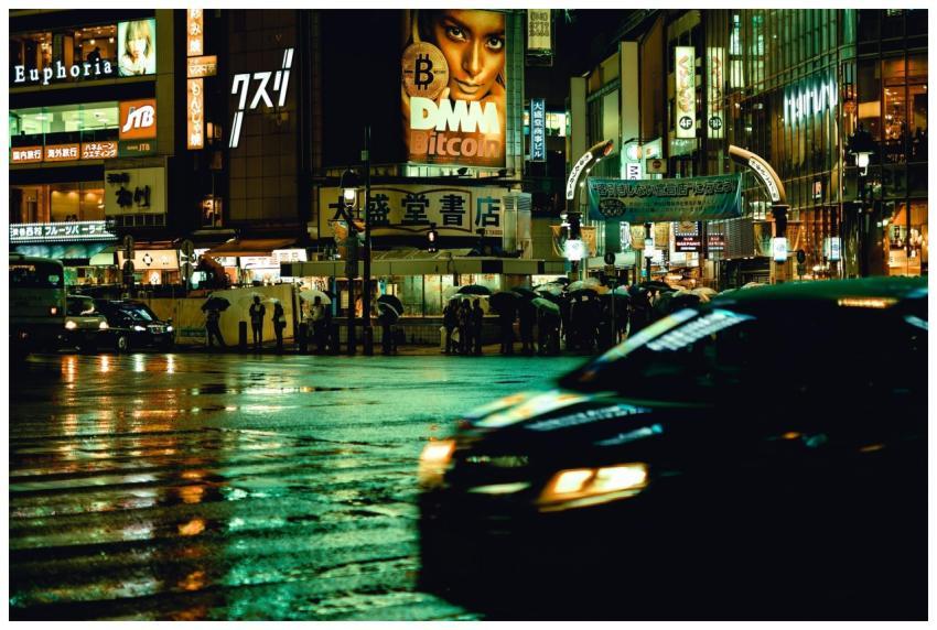 City lights reflecting on wet streets in Shibuya,