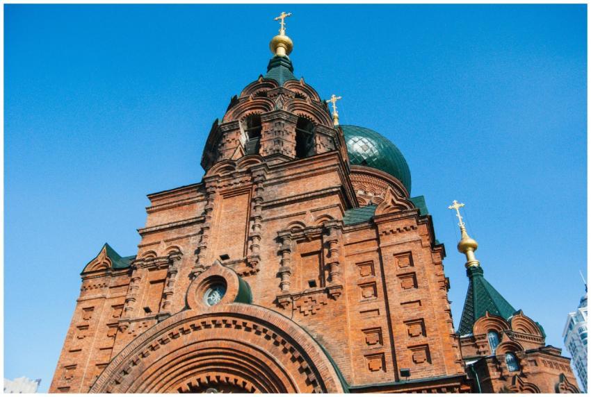 Red brick Orthodox cathedral with ornate domes und