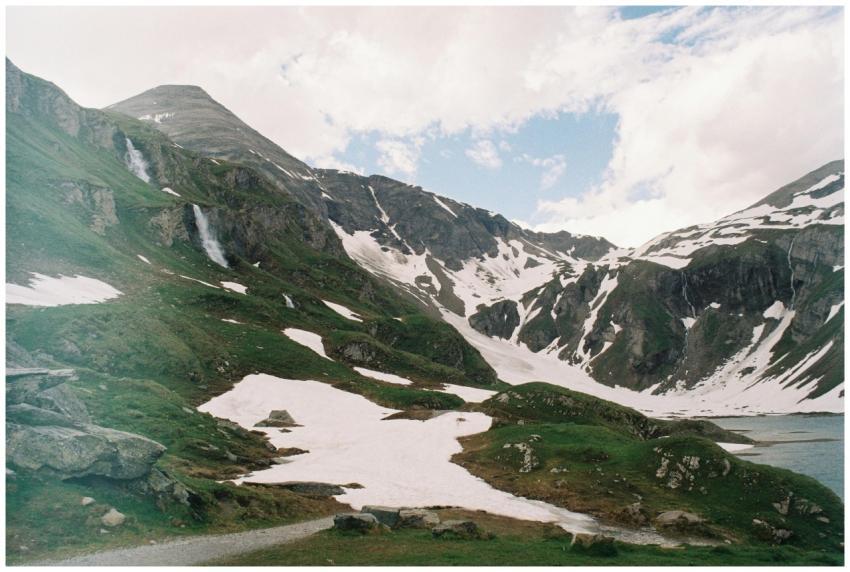Breathtaking view of snow-covered peaks and green
