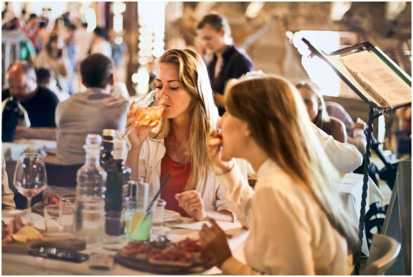 Friends dining in a cozy Italian restaurant, enjoy
