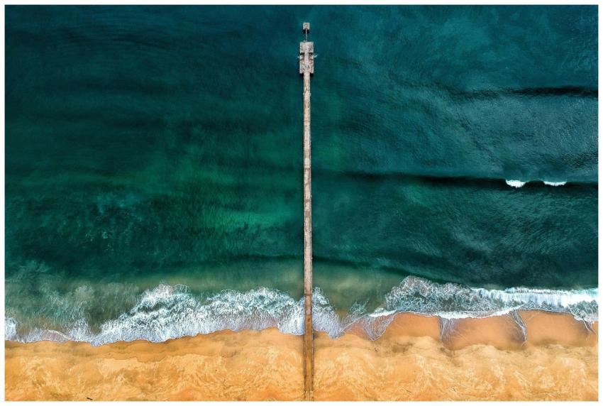 Stunning aerial view of a solitary jetty reaching