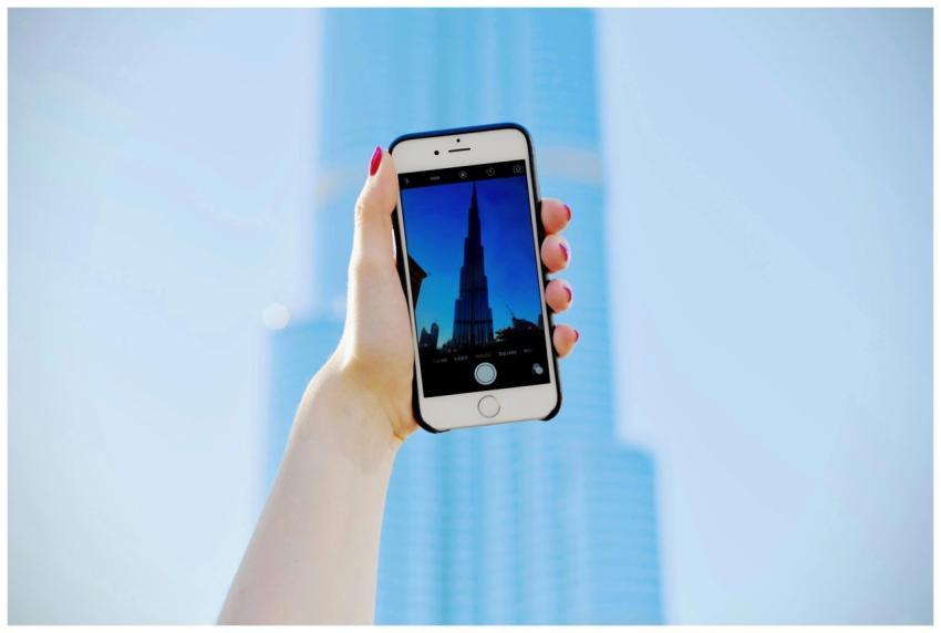 A hand holding a smartphone capturing the iconic B